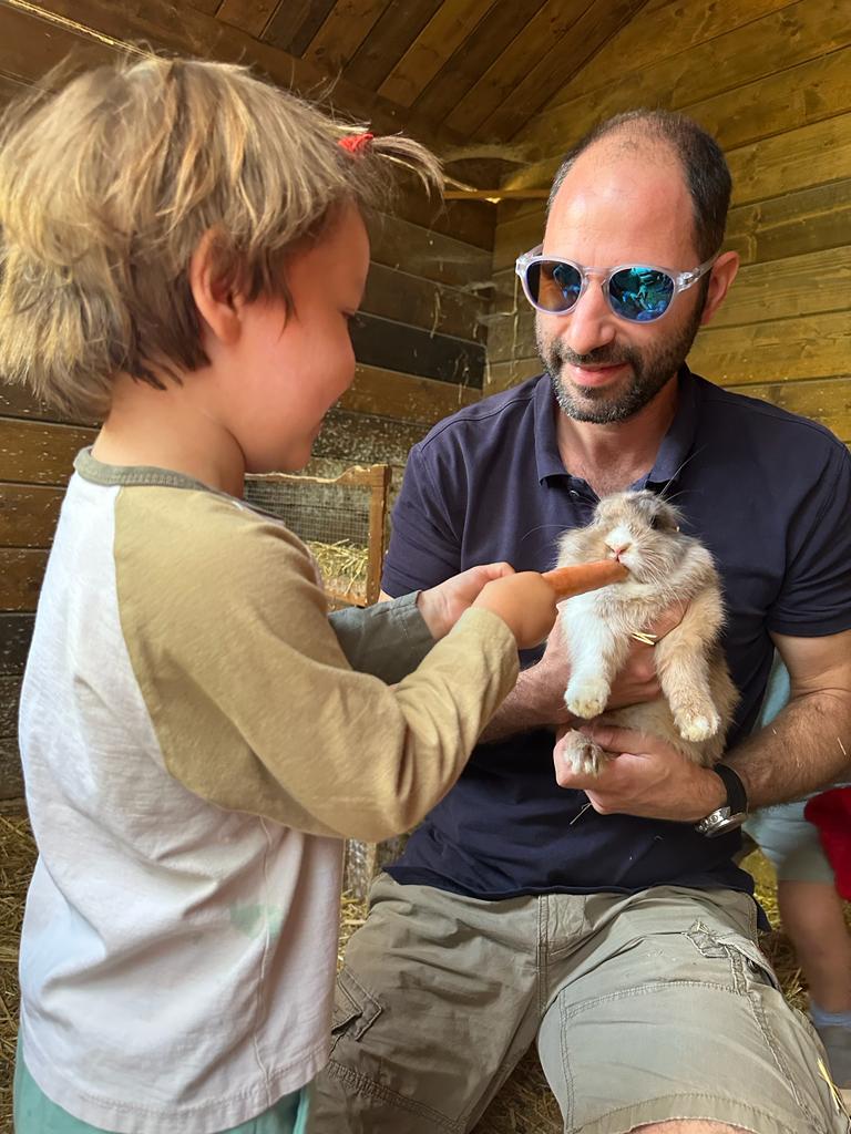 child feeding a rabbit a carrot - child friendly holidays in south of France – country kids