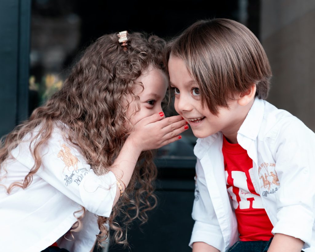 little girl whispering to a little boy - child friendly holidays in south of France – country kids - 2