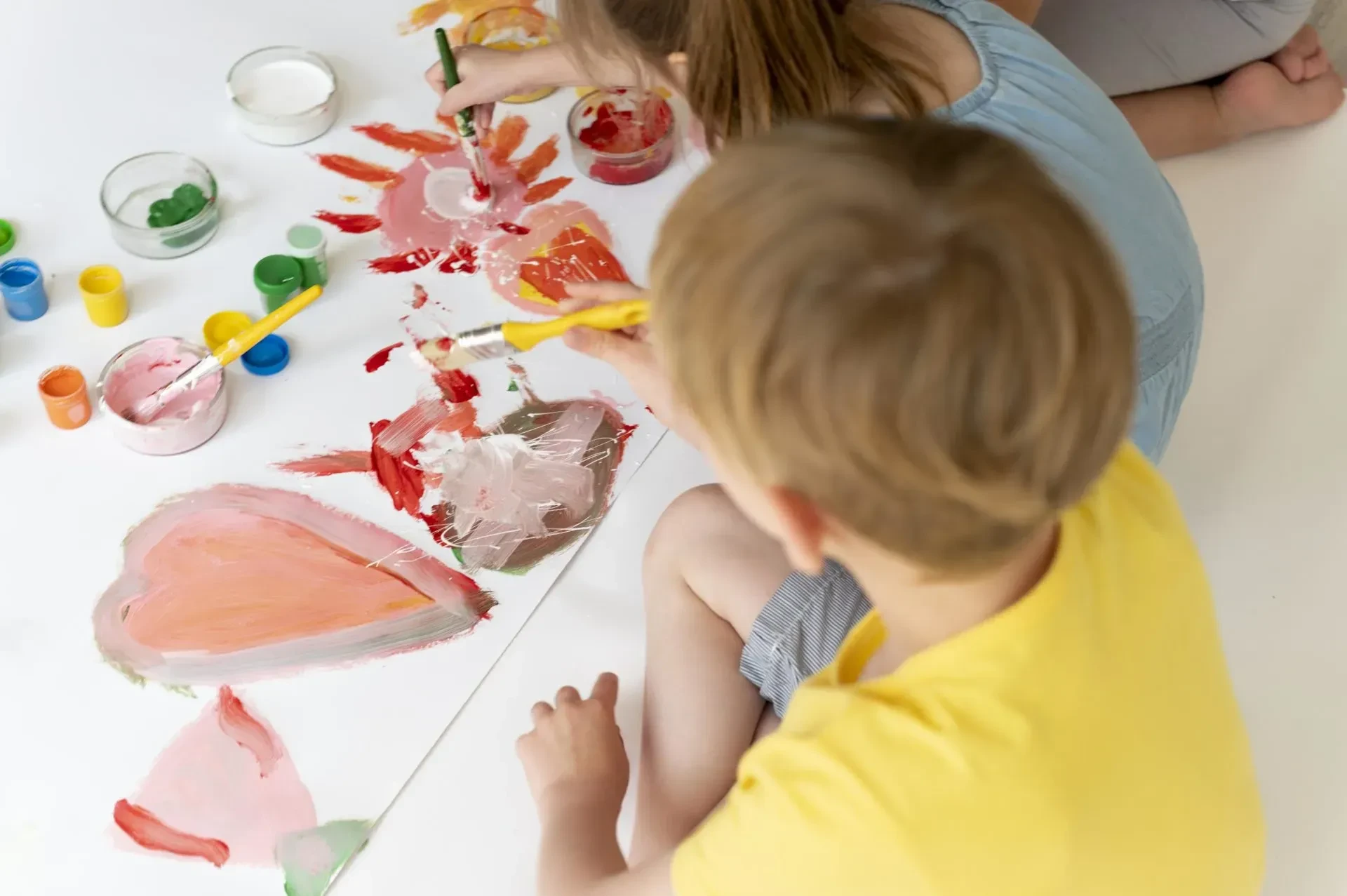 close-up-boy-girl-painting-together-scaled - gallery - kids club south of France