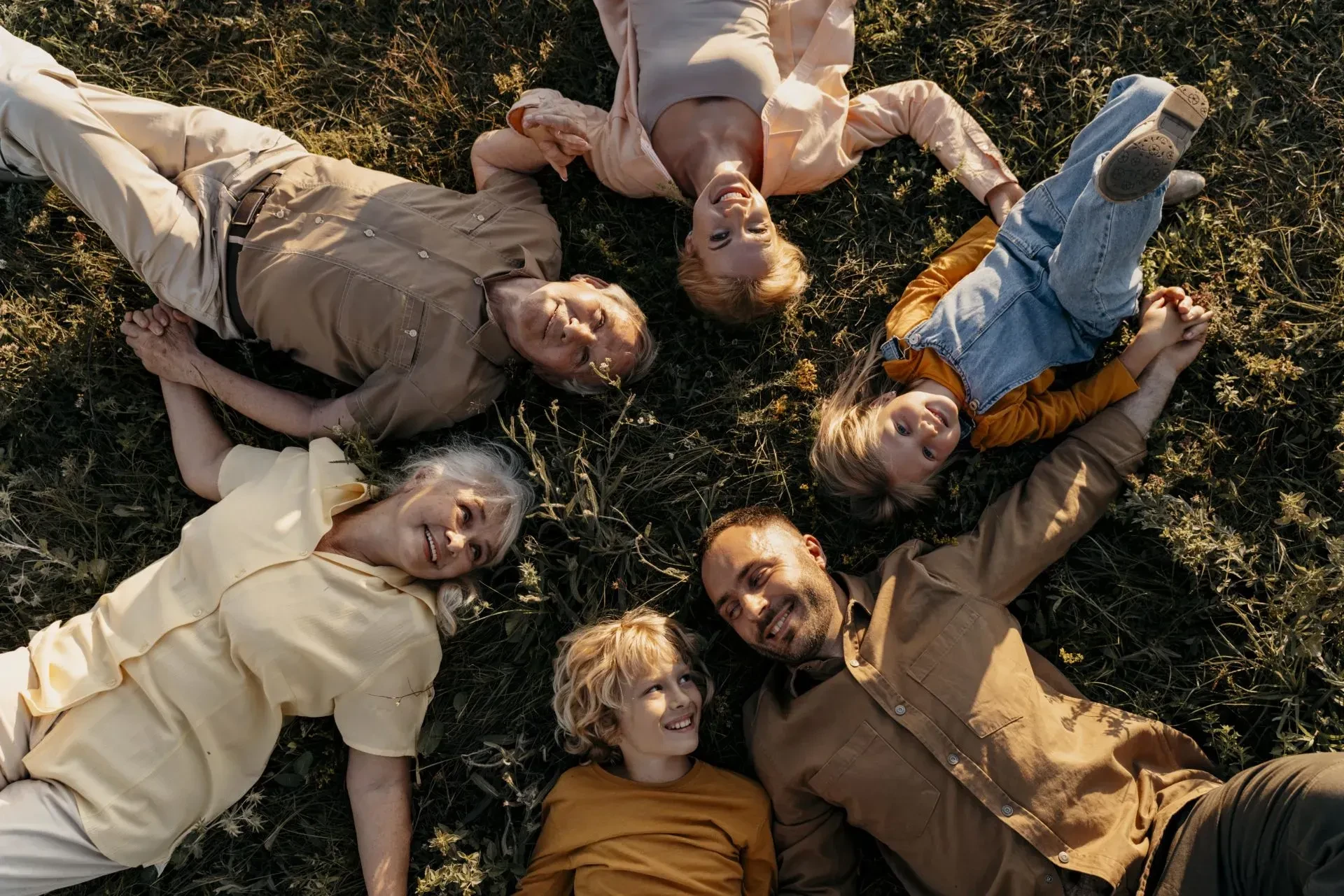 medium-shot-smiley-people-laying-grass-scaled - gallery - kids club south of France