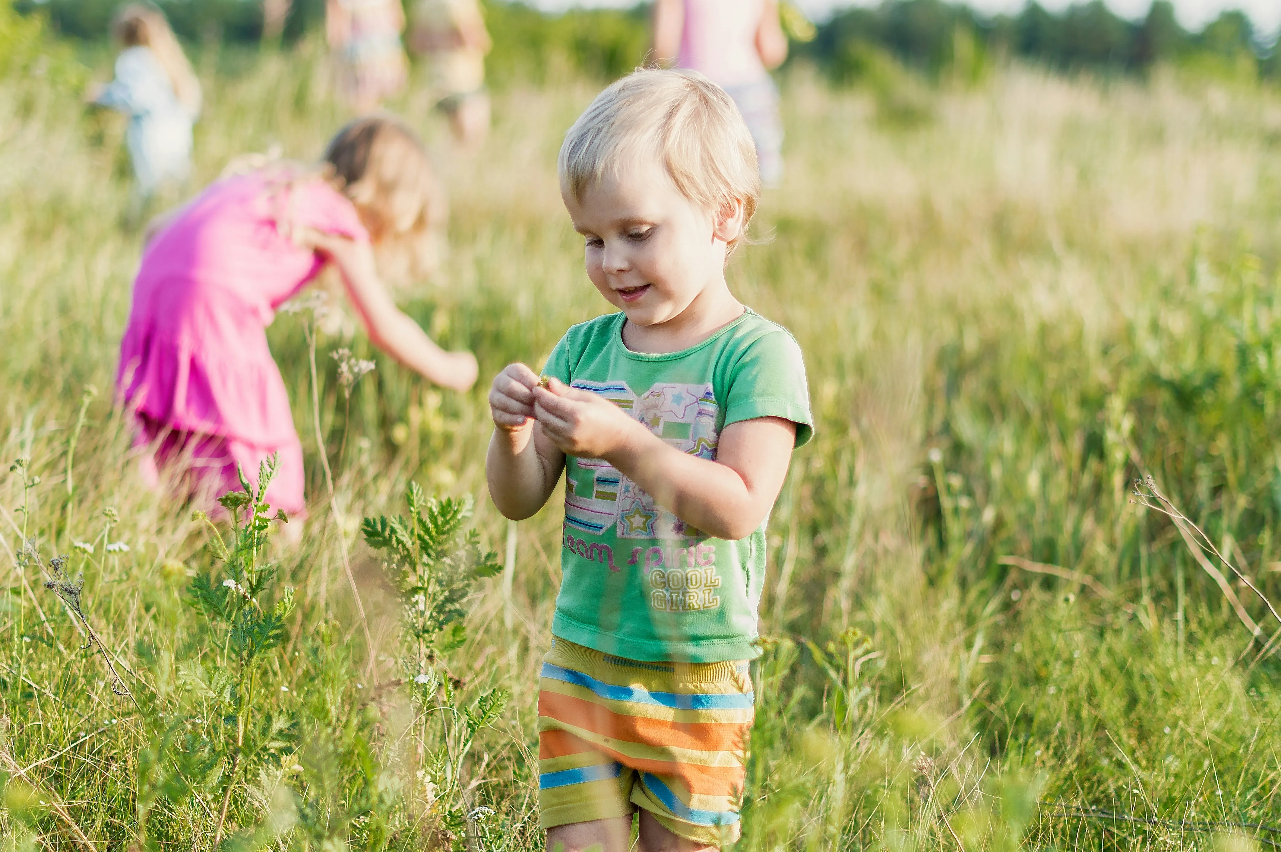 Children playing in a grassy field.