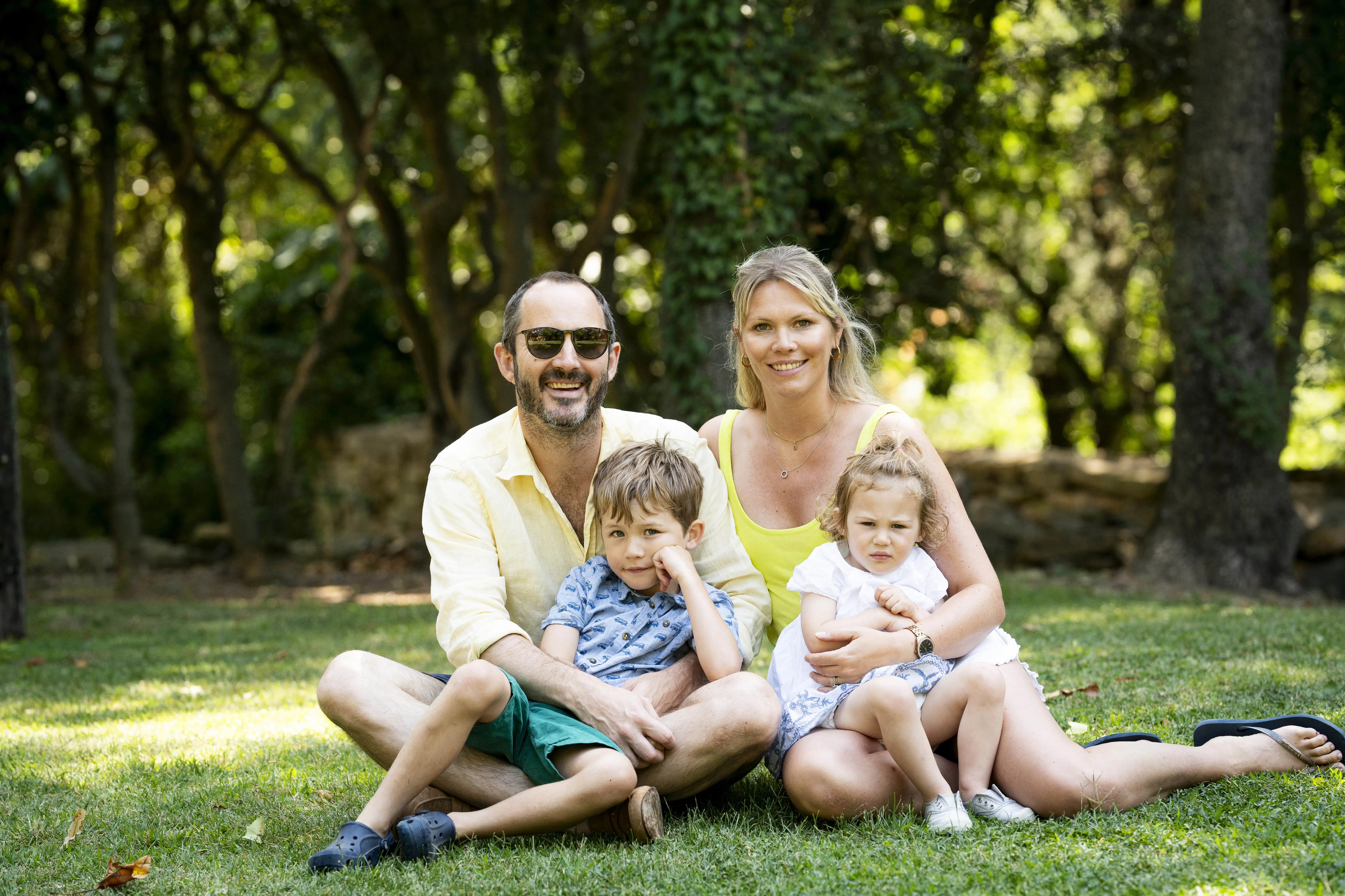 Family sitting together in a park.